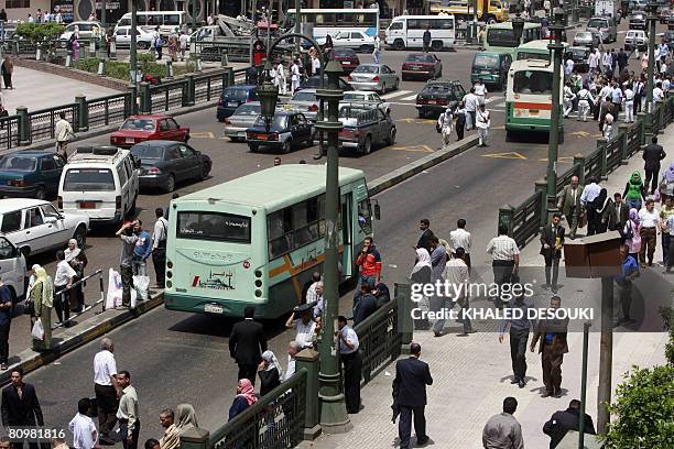 Egyptian pedestrians and traffic clog the streets in downtown Cairo on May 4 despite calls for strikes amid a wave of popular discontent at price...