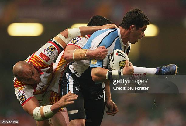 Henry Paul of Harlequins is tackled by Jason Croker of Catalans during the engage Super League "Millennium Magic" match between Catalans Dragons and...