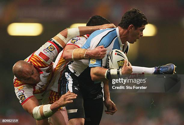 Henry Paul of Harlequins is tackled by Jason Croker of Catalans during the engage Super League "Millennium Magic" match between Catalans Dragons and...