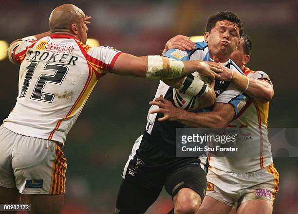 Henry Paul of Harlequins is tackled by Jason Croker of Catalans during the engage Super League "Millennium Magic" match between Catalans Dragons and...