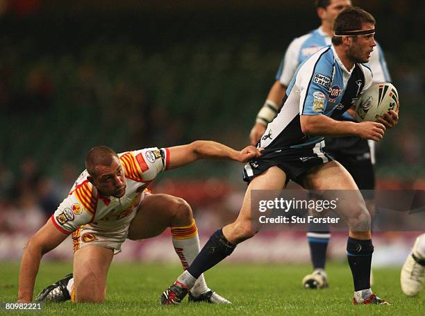 Chad Randall of Harlequins is snagged by Jerome Guisset of Catalans during the engage Super League "Millennium Magic" match between Catalans Dragons...