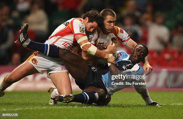 Michael Worrincy of Harlequins is hauled down by the Catalans defence during the engage Super League "Millennium Magic" match between Catalans...