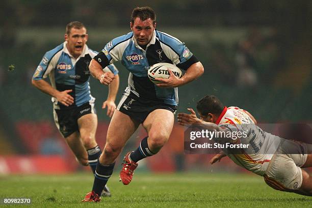 Gareth Haggerty of Harlequins goes past the challenge from Jamal Fakir of Catalans during the engage Super League "Millennium Magic" match between...