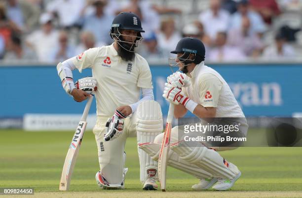 Joe Root and Moeen Ali of England take a break during the first cricket test between England and South Africa at Lord's Cricket Ground on July 6,...