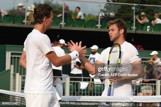 Czech Republic's Tomas Berdych shakes hands with US player Ryan Harrison after winning their men's singles second round match on the fourth day of...