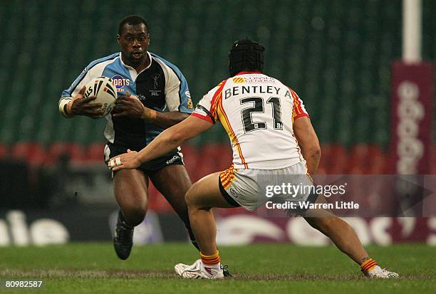 Michael Worrincy of Harlequins is challenged by Andrew Bentley of Catalans during the engage Super League "Millennium Magic" match between Catalans...