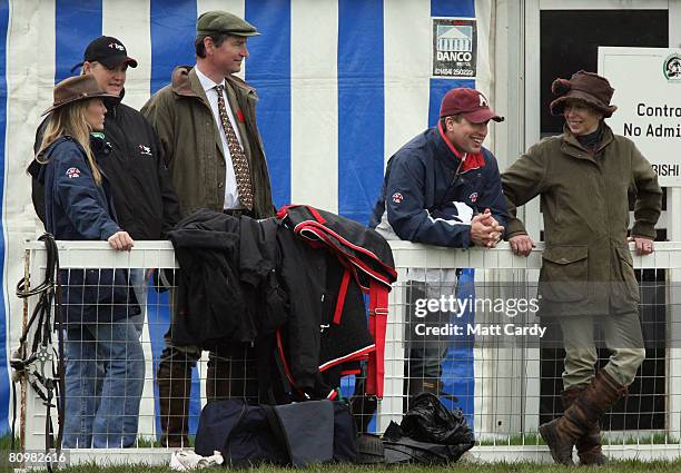 Princess Anne, Princess Royal jokes with her son Peter Phillips as they watch the horses warming up for the show jumping during the Badminton Horse...