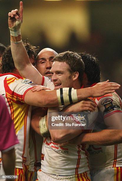 Justin Murphy of Catalans is congratulated by teammates after scoring a try during the engage Super League "Millennium Magic" match between Catalans...