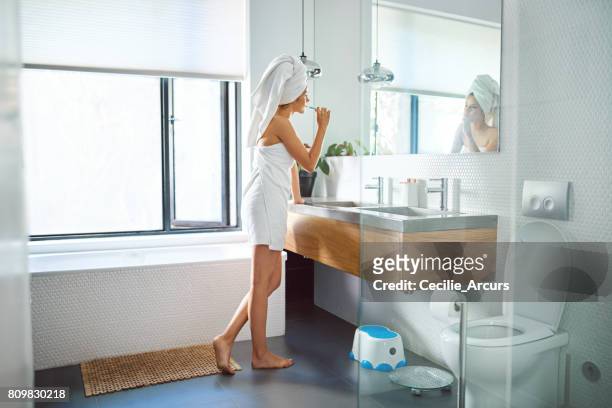 getting ready for the day ahead - domestic bathroom stock pictures, royalty-free photos & images