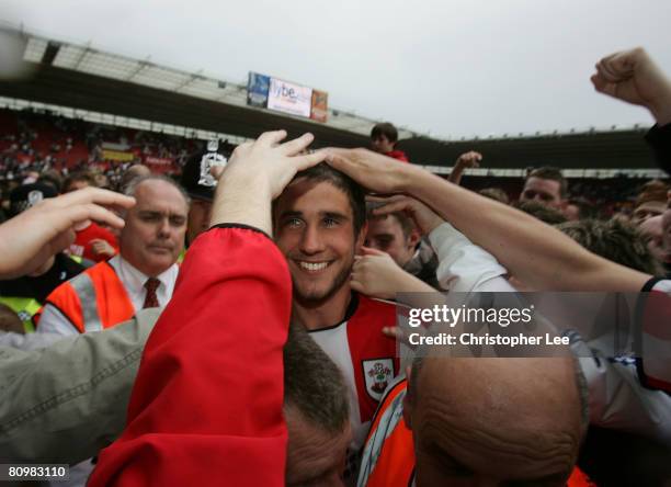 Andrew Surman of Southampton is congratulated by the fans as they celebrate avoiding relegation during the Coca-Cola Championship match between...