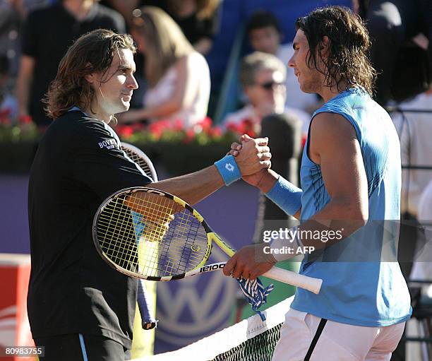 Spanish Rafael Nadal clap hands with Spanish opponent David Ferrer after wins the final match in the Barcelona Open tennis tournament Conde de Godo...