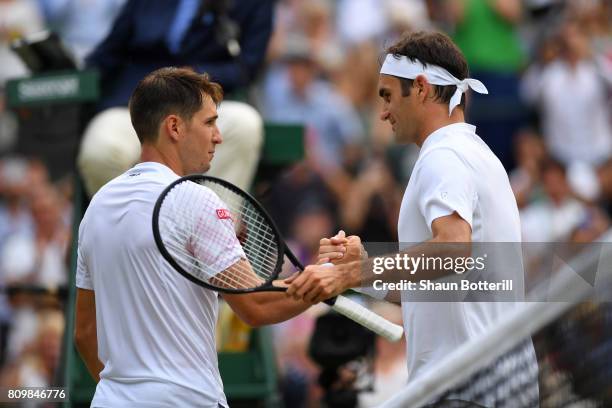 Roger Federer of Switzerland and Dusan Lajovic of Serbia shake hands after the Gentlemen's Singles second round match on day four of the Wimbledon...