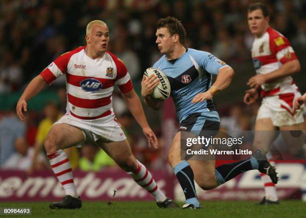 Paul Clough of St Helens is challenged by Eamon O'Carroll of Wigan during the engage Super League "Millennium Magic" match between St Helens and...