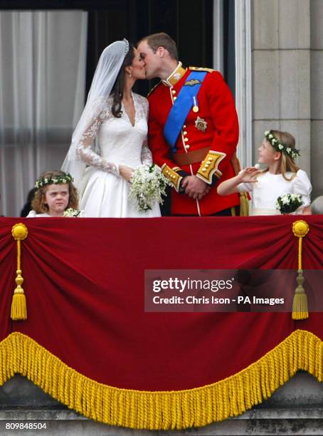 Prince William and his wife Kate Middleton, who has been given the title of The Duchess of Cambridge, kiss on the balcony of Buckingham Palace,...