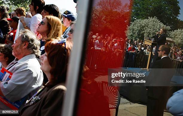 The image of Democratic presidential hopeful Sen. Hillary Clinton speaking is reflected in a store front window during a campaign event at a Hillary...