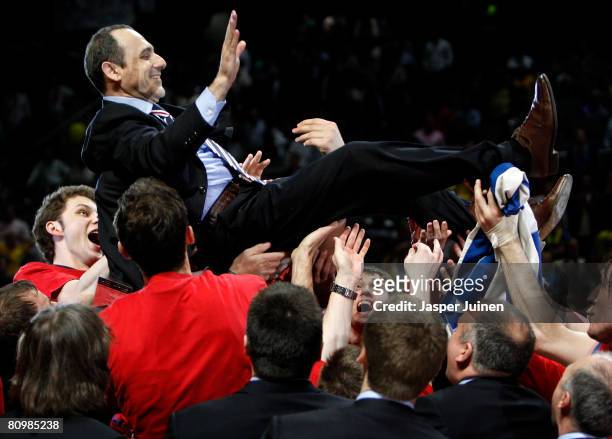 Head Coach Ettore Messina of CSKA Moscow is hoisted up by his players as they celebrate victory at the end of the Euroleague Final Four final...