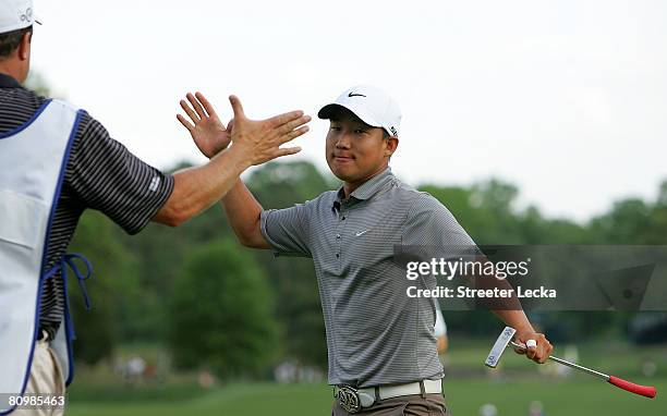 Anthony Kim celebrates with his caddie after winning the Wachovia Championship at Quail Hollow Country Club on May 4, 2008 in Charlotte, North...