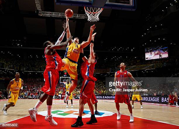 Esteban Batista of Maccabi Elite is blocked by Artem Zabelin and Marcus Goree of CSKA Moscow during the Euroleague Final Four final basketball match...