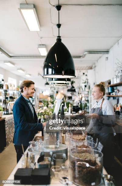 man ordering cake at cozy café - boutique stock pictures, royalty-free photos & images