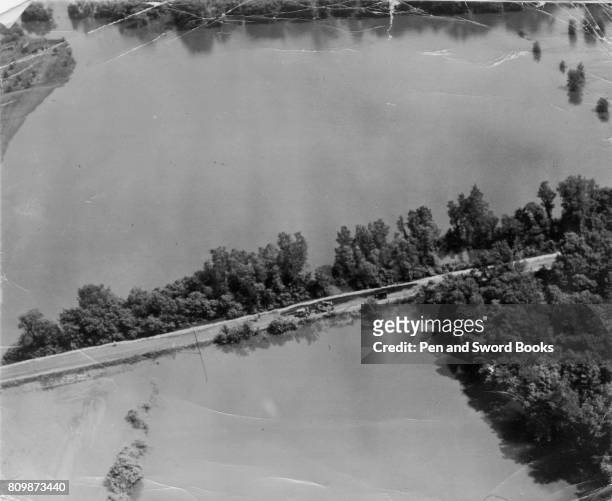 Pre-D-day American reconnaissance picture of the flooding and one of the raised exit roads from the beach. .