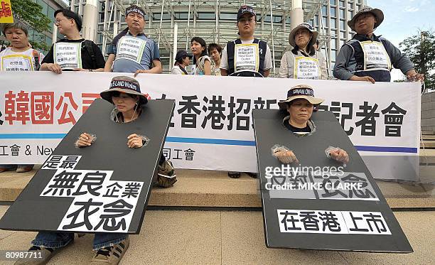 Protesters, including workers from Chinese retailer E-Land Fashion China, the Hong Kong Confederation of Trade Unions and other labour organisations...