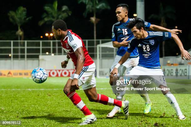 South China midfielder Mahama Awal fights for the ball with Johor Darul Ta'zim defender Muhammad Fazly Bin Mazlan and Johor Darul Ta'zim forward Mohd...