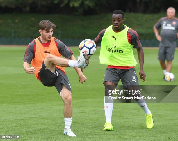 Dan Crowley and Marc Bola of Arsenal during a training session at London Colney on July 6, 2017 in St Albans, England.