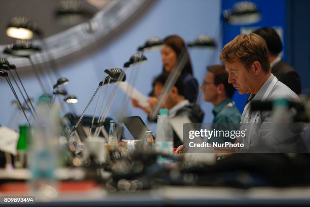 Journalists are seen working at the press center in the Hamburg Messe on 6 July, 2017 ahead of the 2017 G20 meeting.