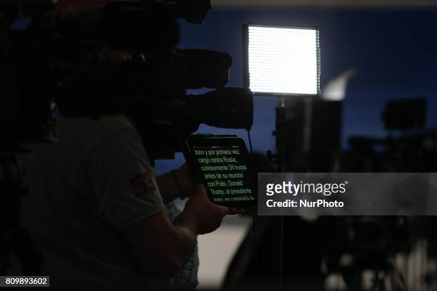 Man is seen holding a tablet scrolling text for a television reporter at the press center in the Hamburger Messe where the 2017 G20 meeting will be...