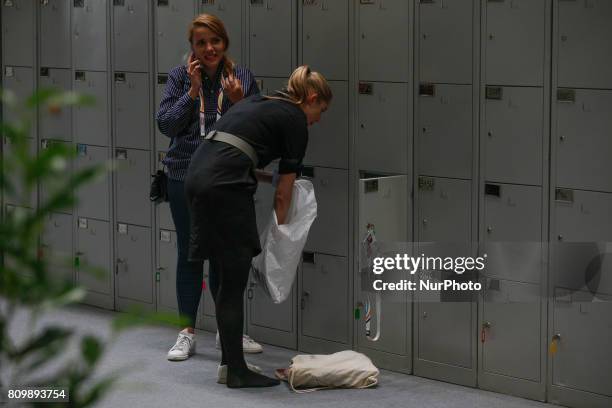 Journalists are seen using lockers at the press center located in the Hamburg Messe und Congress center on 6 July, 2017 where the 2017 G20 meeting...