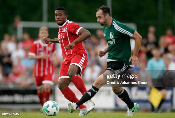 Marco Hingerl of Wolfratshausen and Franck Evina of Bayern fight for the ball during the preseason friendly match between BCF Wolfratshausen and...