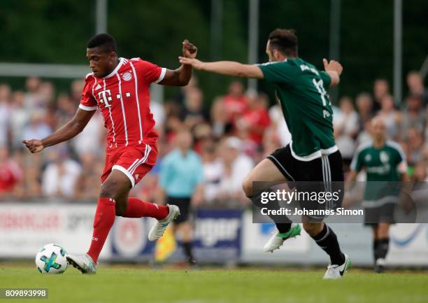 Marco Hingerl of Wolfratshausen and Franck Evina of Bayern fight for the ball during the preseason friendly match between BCF Wolfratshausen and...