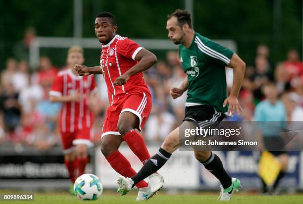 Vincenzo Potenza of Wolfratshausen and Franck Evina of Bayern fight for the ball during the preseason friendly match between BCF Wolfratshausen and...