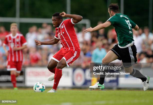 Vincenzo Potenza of Wolfratshausen and Franck Evina of Bayern fight for the ball during the preseason friendly match between BCF Wolfratshausen and...