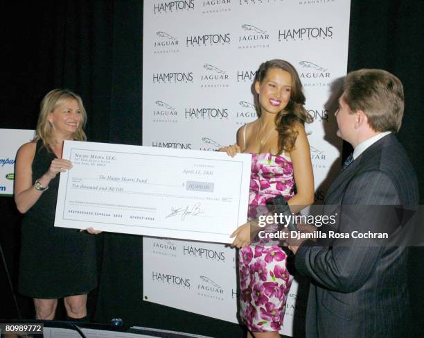 Debra Halpert, Publisher of Hamptons Magazine, Petra Nemcova and Gary Flom, President and CEO of Manhattan Automobile Company?presenting check for...