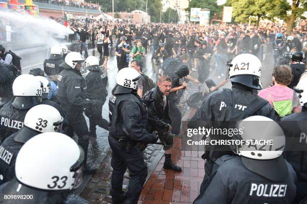 Riot police use water cannon during the "Welcome to Hell" rally against the G20 summit in Hamburg, northern Germany on July 6, 2017. Leaders of the...