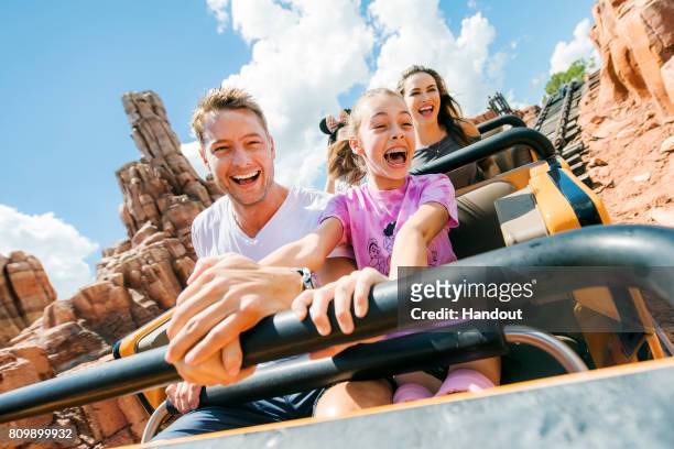 In this handout provided by Disney Parks, actor Justin Hartley celebrates his daughter Isabella Justice's thirteenth birthday by braving Big Thunder...
