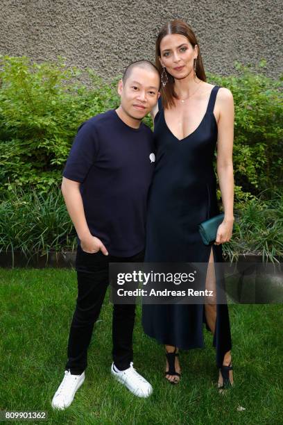 Jason Wu and Eva Padberg pose after the Hugo Boss presentation during 'Der Berliner Mode Salon' Spring/Summer 2018 at St. Agnes Church on July 6,...