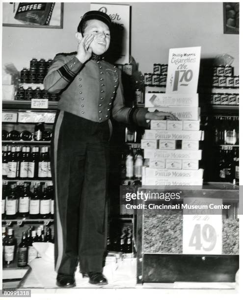 American advertising pitchman Johnny Roventini stands on a counter in his bellhop uniform to deliver a 'Call for Phillip Morris,' the tobacco...