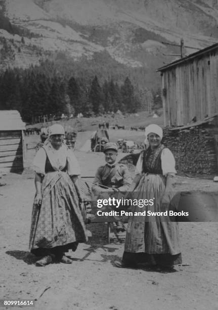 Italian women of Cortina taking a convalesent wounded Officer for an airing in a small farm waggon.
