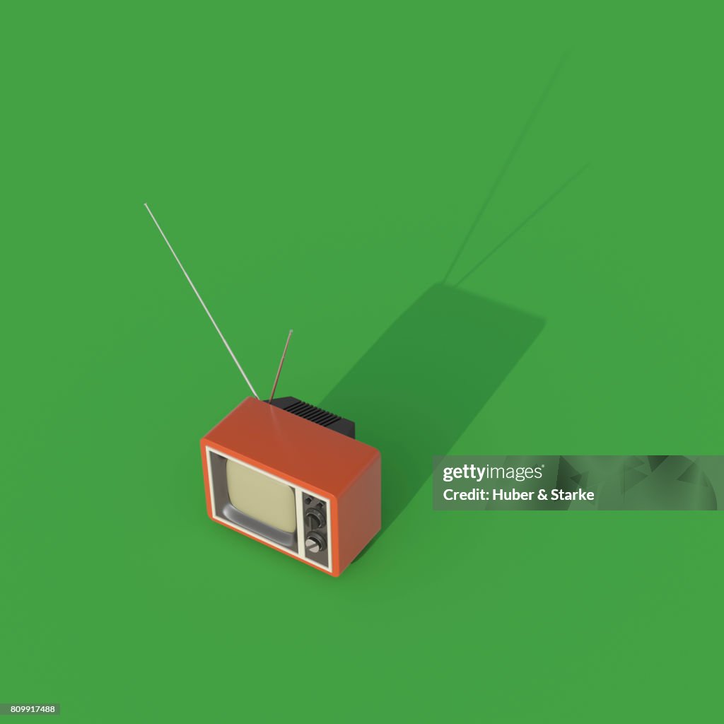 Retro styled television set  on green background