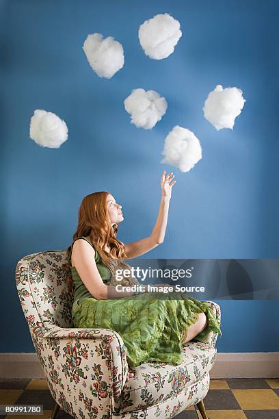 a young woman reaching for clouds - sitting on a cloud stock pictures, royalty-free photos & images