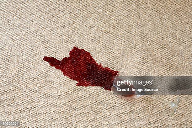 red wine spilled on carpet - teppich stock-fotos und bilder