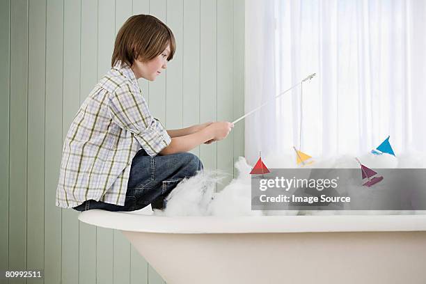 a boy fishing in a bathtub - boat in bath tub stock pictures, royalty-free photos & images