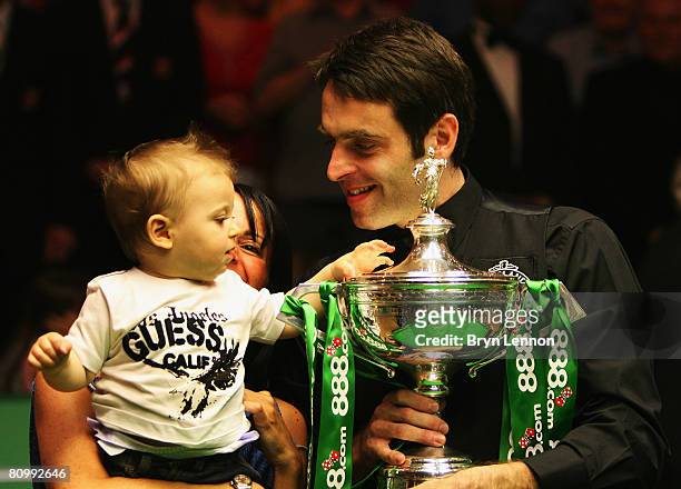 Ronnie O'Sulliivan of England celebrates with his son Ronnie after winning the final of the 888.com World Snooker Championships at the Crucible...