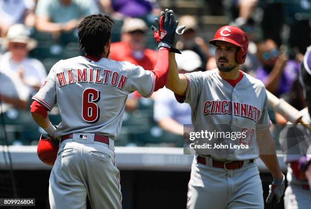 Cincinnati Reds center fielder Billy Hamilton high fives Cincinnati Reds left fielder Adam Duvall after scoring on a first baseman Joey Votto hit in...