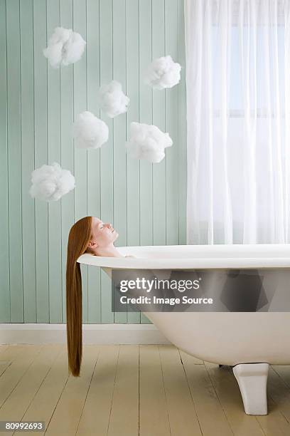 a woman relaxing in the bath - cotton cloud stock pictures, royalty-free photos & images