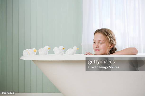 a girl looking at toy ducks - rubber ducks in a row stock pictures, royalty-free photos & images