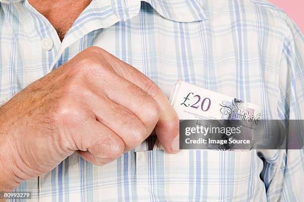 man with banknotes in his pocket - hands in pockets stock-fotos und bilder