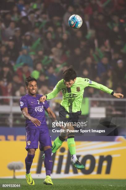 Al Ain midfielder Lucas Fernandes Caio fights for the ball with Jeonbuk Hyundai Motors FC defender Kim Changsoo during the 2016 AFC Champions League...